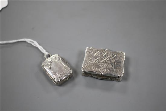 A Victorian silver shaped rectangular vinaigrette, Hilliard & Thomason, Birmingham, 1884 and one other.